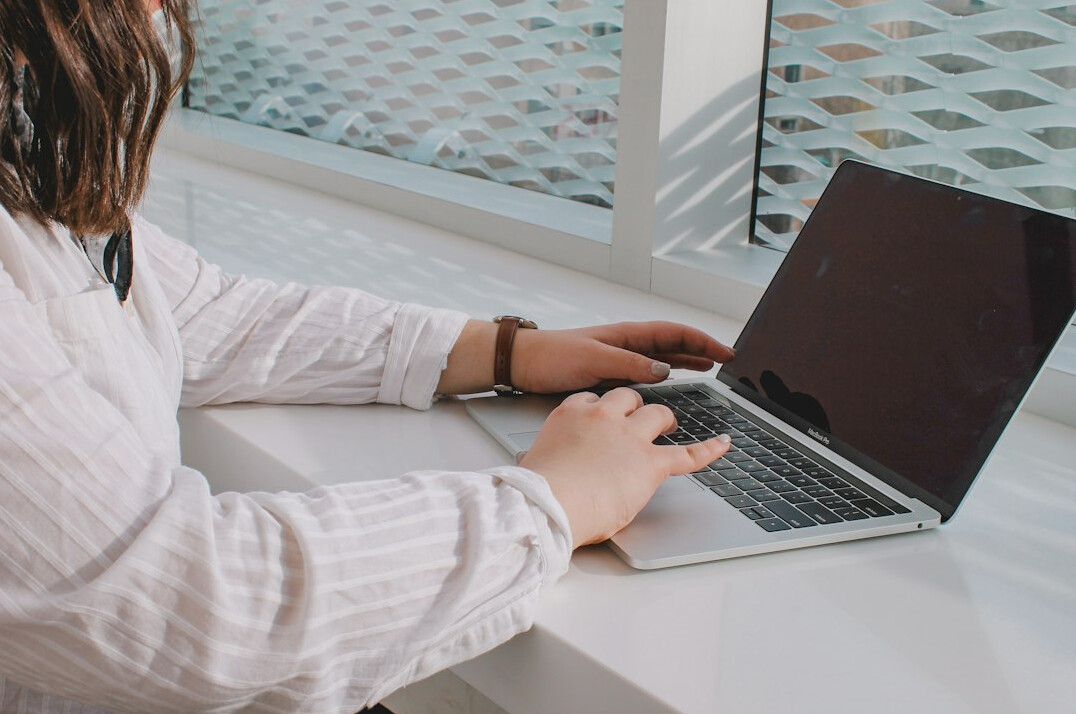 writer typing on laptop
